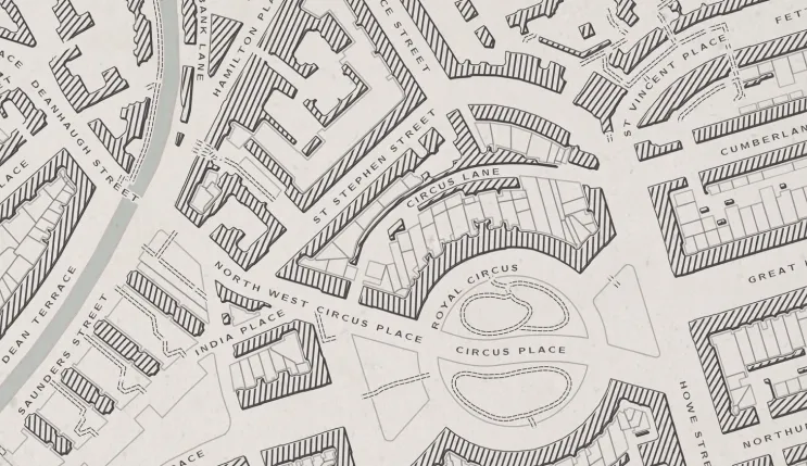 A monochrome map of city streets and buildings featured on the QGIS website
